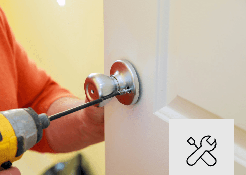 Professional handyman repairing a door Mor Handy general repair service installing hardware in a Maryland home